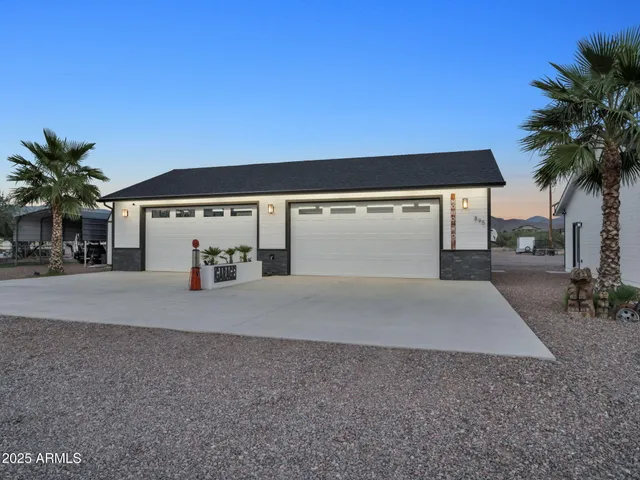 a view of a house with a yard and garage