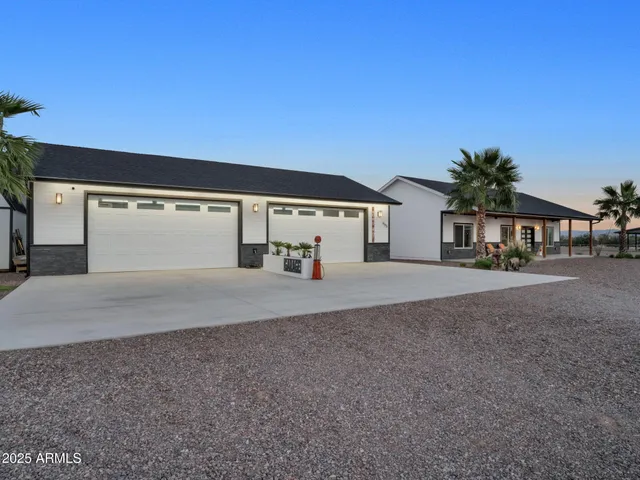a kitchen with stainless steel appliances kitchen island granite countertop a refrigerator and cabinets