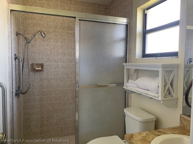 108 Lime Road Northeast Lake Placid, FL 33852 - Photo 16 of 17 a bathroom with a toilet sink and shower