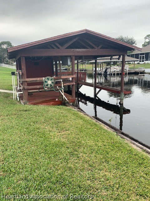 108 Lime Road Northeast Lake Placid, FL 33852 - Photo 2 of 17 a view of a patio with table and chairs under an umbrella next to a yard