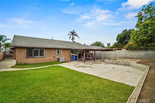 a view of a house with a yard and sitting area