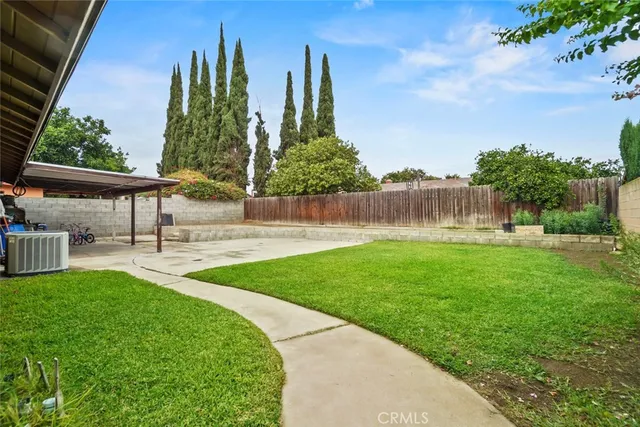 a view of a garden with a bench in the background
