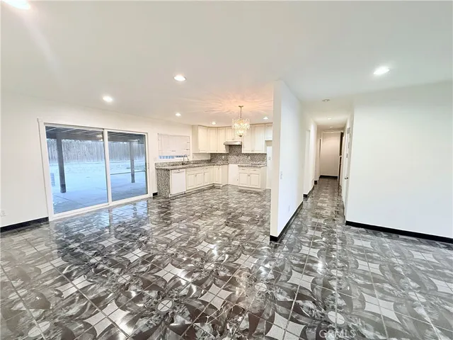 a view of a electric appliances in kitchen and an empty room
