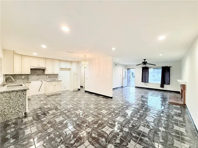 a view of a kitchen with a sink and cabinets