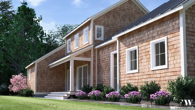 a front view of a house with a garden and plants