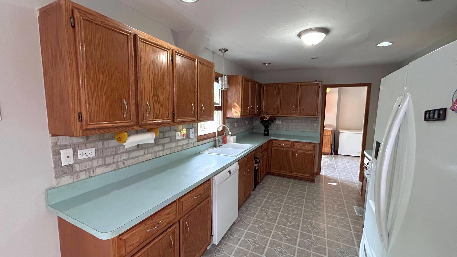 745 Longlane Road New Lenox, IL 60451 - Photo 3 of 17 a kitchen with stainless steel appliances granite countertop a sink refrigerator and cabinets