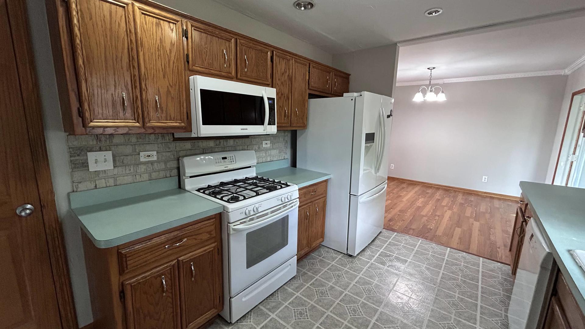 745 Longlane Road New Lenox, IL 60451 - Photo 5 of 17 a kitchen with a stove and a microwave