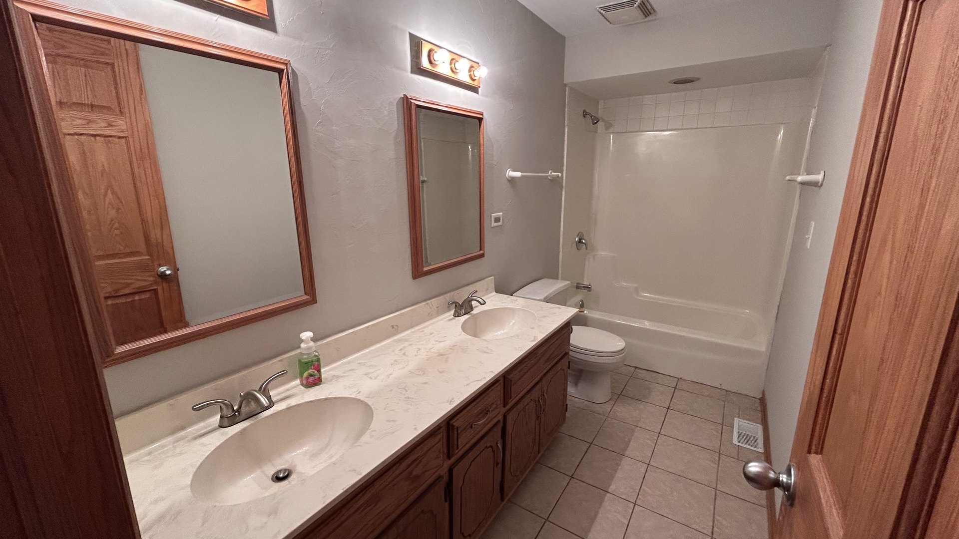 745 Longlane Road New Lenox, IL 60451 - Photo 7 of 17 a bathroom with a double vanity sink a toilet and a mirror
