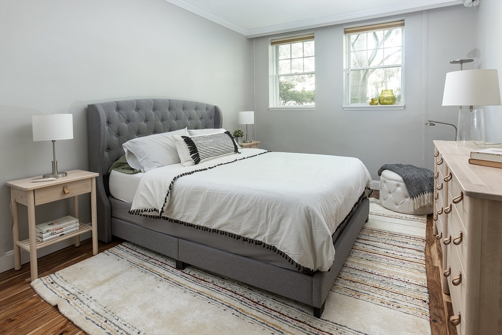 126 Amory Street, Unit B4 Brookline, MA 02446 - Photo 6 of 8 a bedroom with a bed and a lamp on dresser