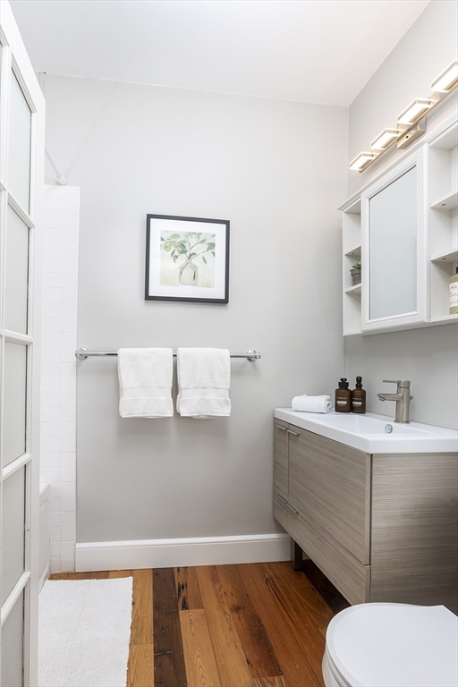 126 Amory Street, Unit B4 Brookline, MA 02446 - Photo 7 of 8 a bathroom with a toilet a sink and mirror