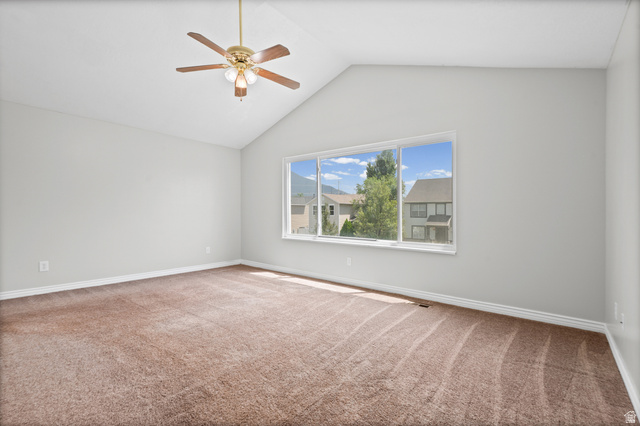 1346 Archmore Drive Springville, UT 84663 - Photo 14 of 32 Spacious room featuring vaulted ceilings, a large window, light-toned wall finishes, and a ceiling fan with integrated lighting