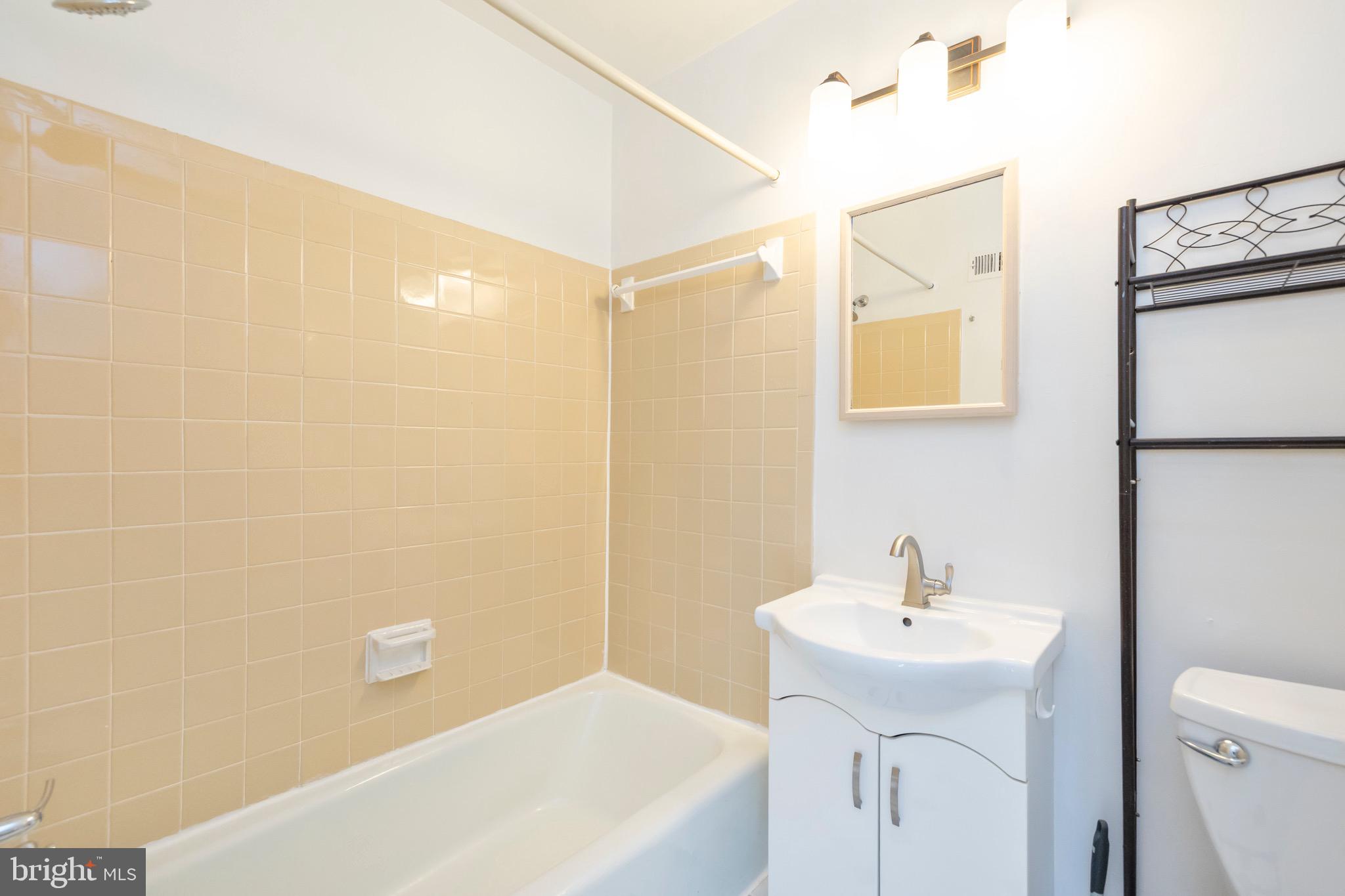 12265 Greenleaf Avenue Potomac, MD 20854 - Photo 16 of 25 a bathroom with a sink a toilet and shower