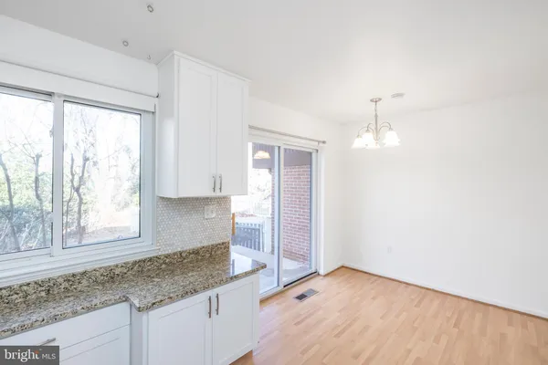 a kitchen with granite countertop a sink and a window