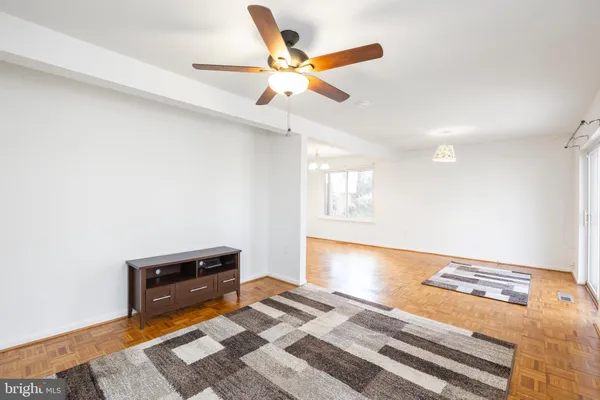 a living room with couch and a ceiling fan