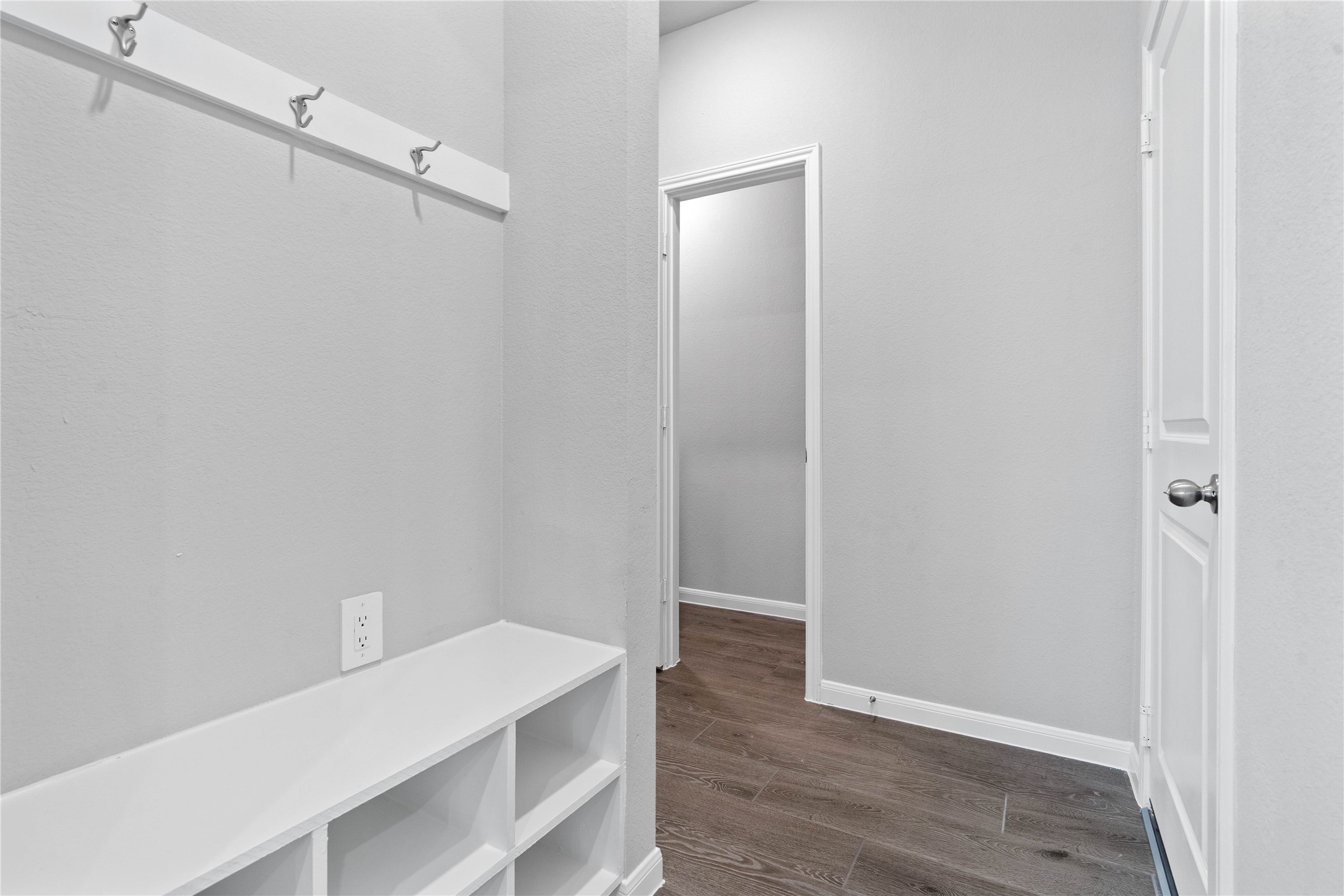 19657 Montgomery Rdg Way Montgomery, TX 77316 - Photo 20 of 49 Across from the kitchen is this dedicated area features a custom built-in bench with hooks, perfect for organizing coats, bags, and shoes right off the main hallway, keeping the rest of the home tidy.