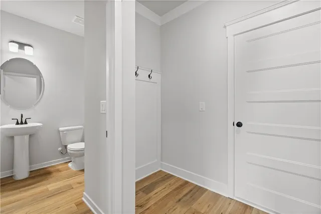 a view of an empty room with wooden floor fireplace and a window