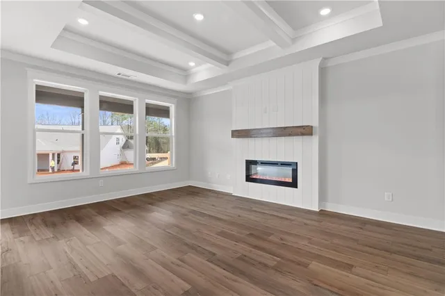 a view of a room with wooden floor and a window