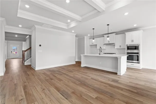 a view of a hallway with wooden floor