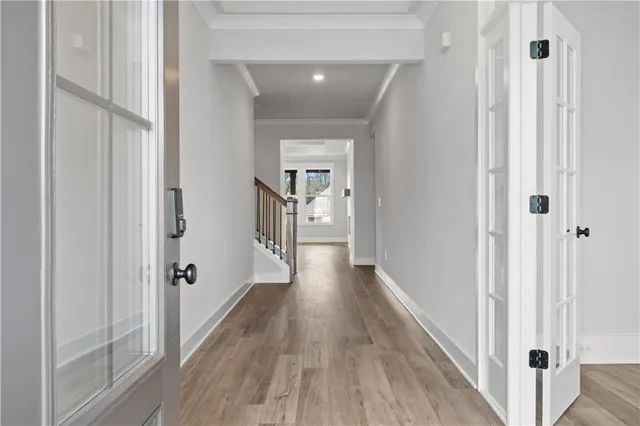 a large kitchen with kitchen island white cabinets and wooden floor