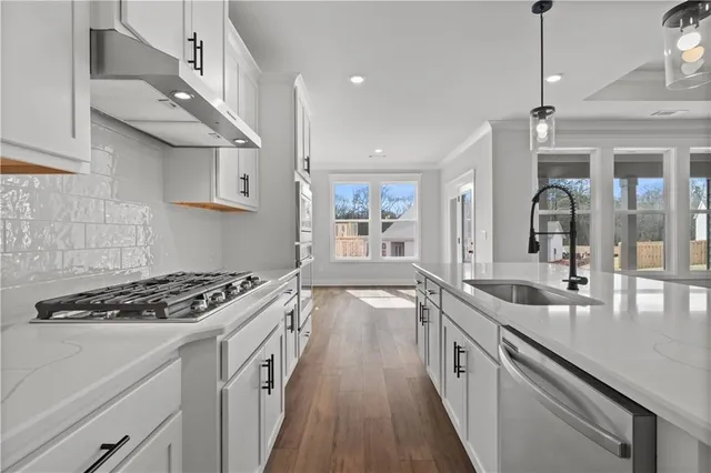 a close view of a stove a microwave and cabinets
