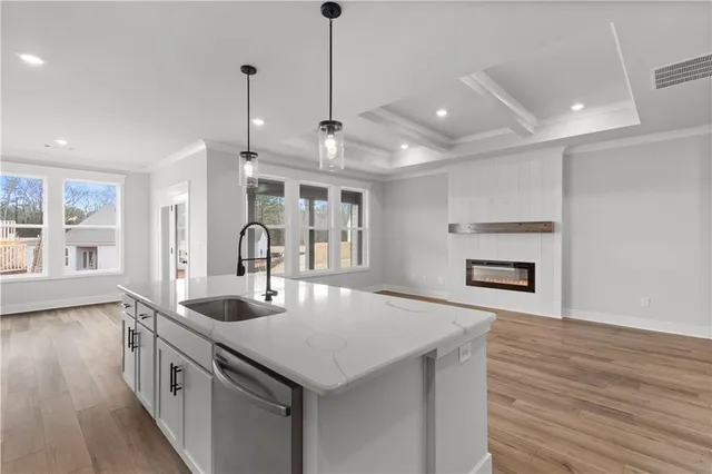 a kitchen with a sink and chandelier