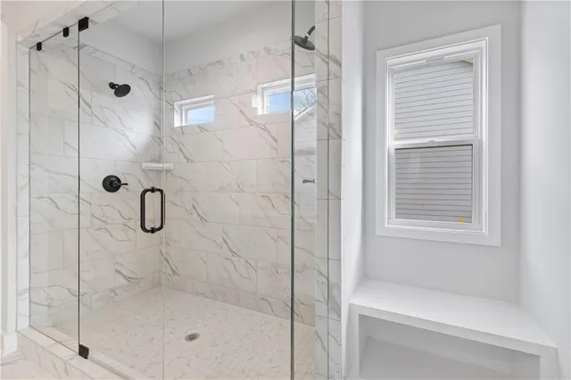 a spacious bathroom with a double sink shower and a mirror