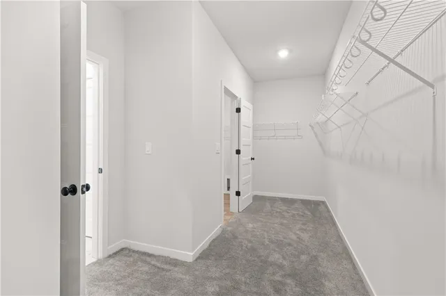 a view of staircase with wooden floor and white walls