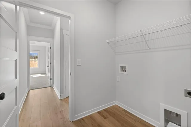 a view of a hallway with wooden floor and windows