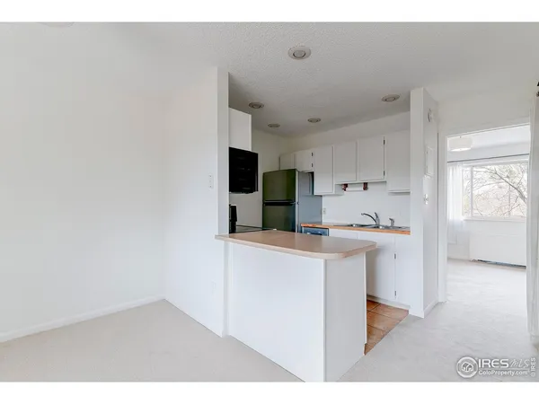 a kitchen with kitchen island a sink stainless steel appliances and cabinets