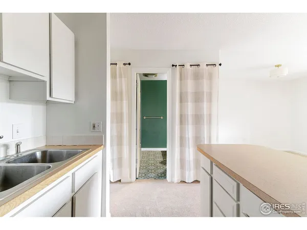 a kitchen with a sink cabinets and a wooden floor