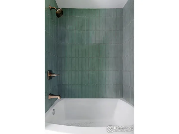 a bathroom with a bathtub and shower