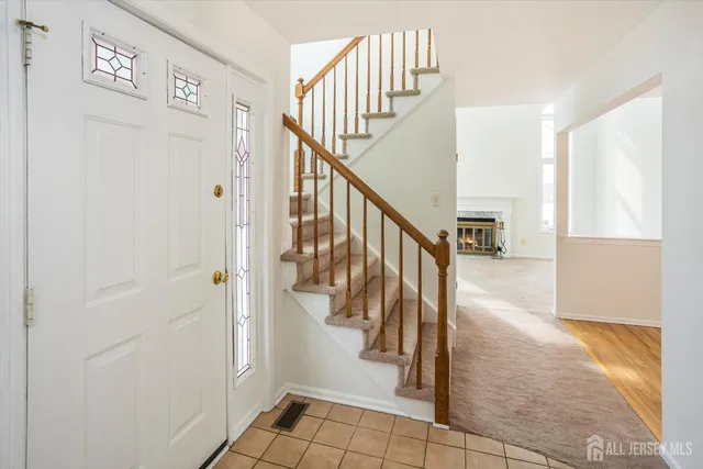 an empty room with windows and fireplace