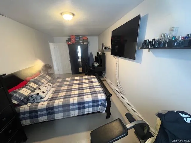 a bedroom with furniture and flat screen tv