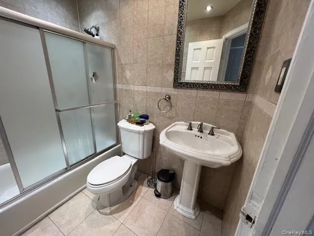 a white toilet sitting next to a bathroom sink