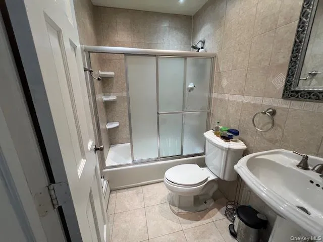 a white toilet sitting next to a bathroom sink