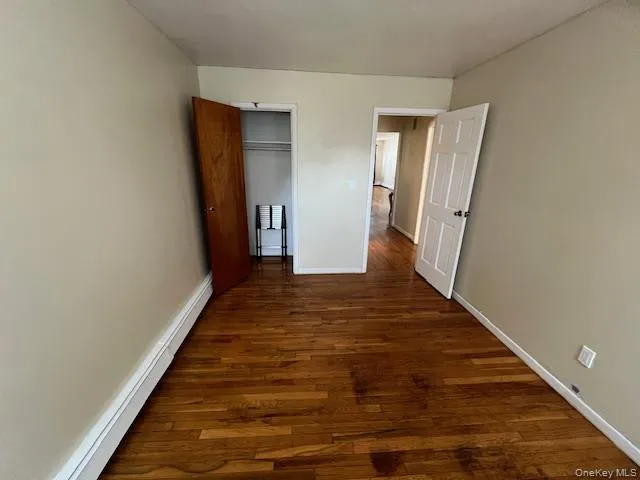 a view of a hallway with wooden floor and entryway