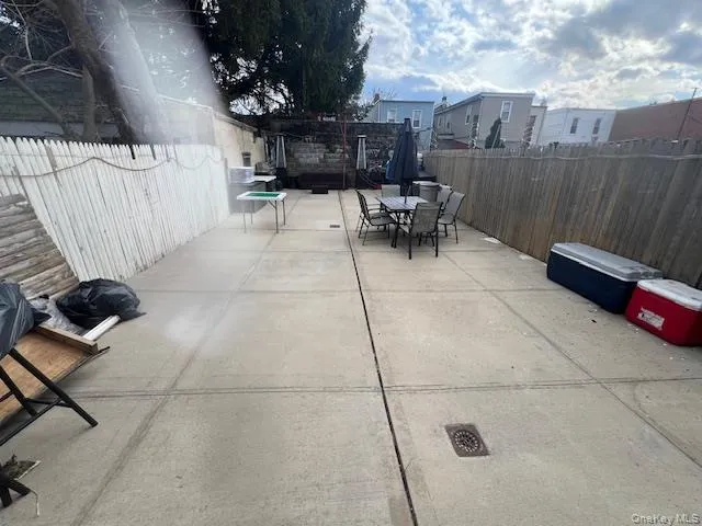 a view of a patio with a table and chairs