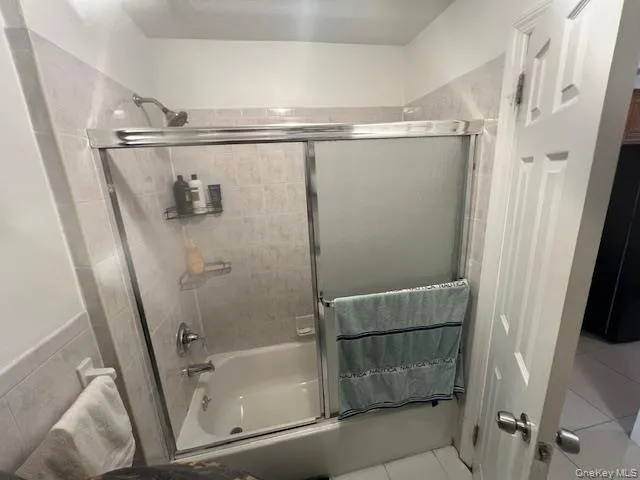 a bathroom with a glass shower door