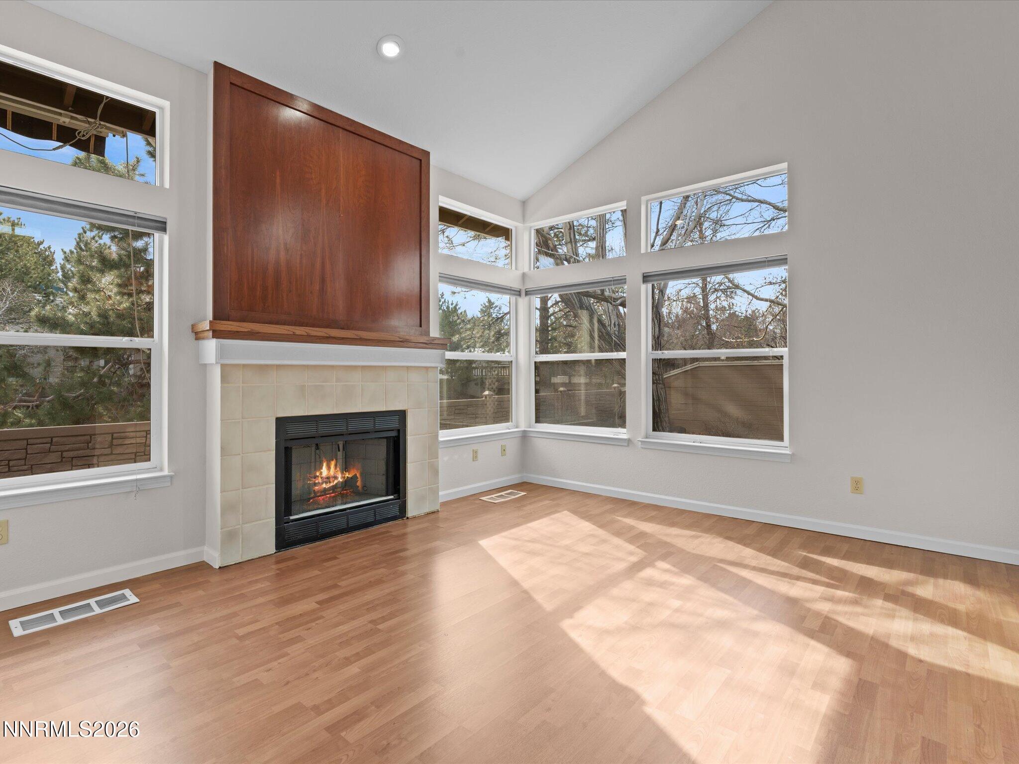 1280 Bridlewood Way Reno, NV 89509 - Photo 13 of 57 a view of an empty room with a window and fireplace