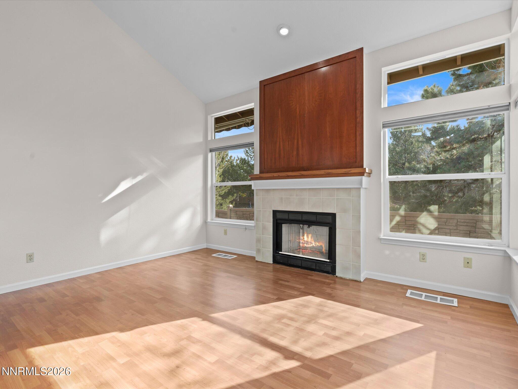 1280 Bridlewood Way Reno, NV 89509 - Photo 15 of 57 a view of an empty room with a window and a fireplace