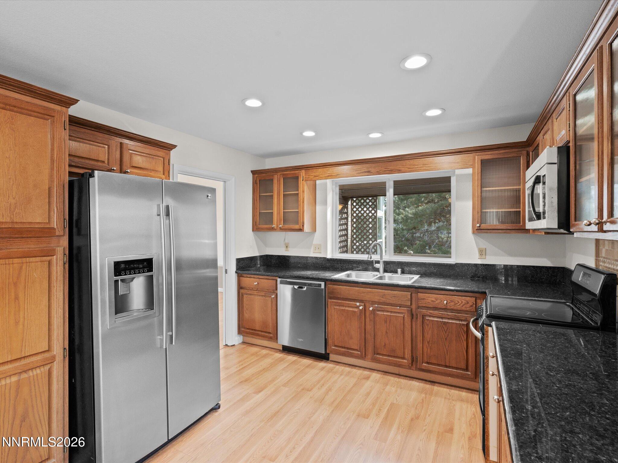 1280 Bridlewood Way Reno, NV 89509 - Photo 16 of 57 a large kitchen with granite countertop a large counter top stainless steel appliances and windows