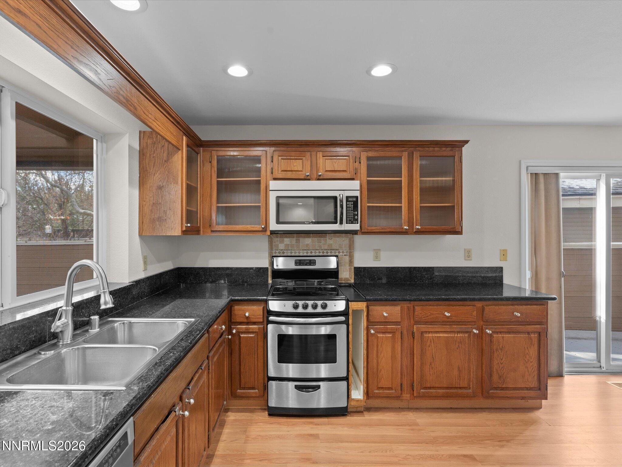1280 Bridlewood Way Reno, NV 89509 - Photo 17 of 57 a kitchen with stainless steel appliances granite countertop a sink and a stove