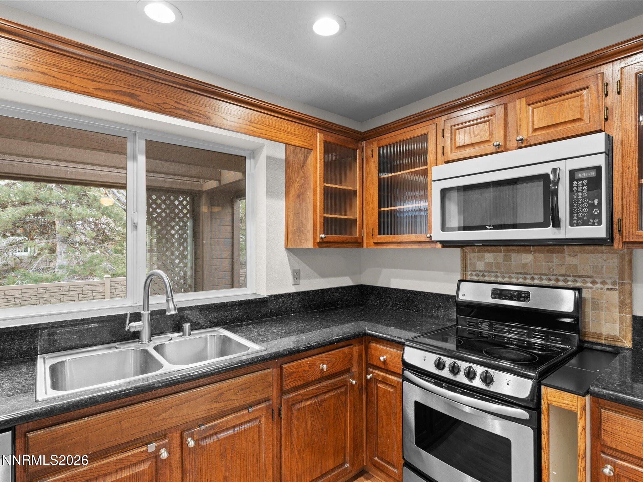 1280 Bridlewood Way Reno, NV 89509 - Photo 18 of 57 a kitchen with granite countertop a sink stainless steel appliances and cabinets
