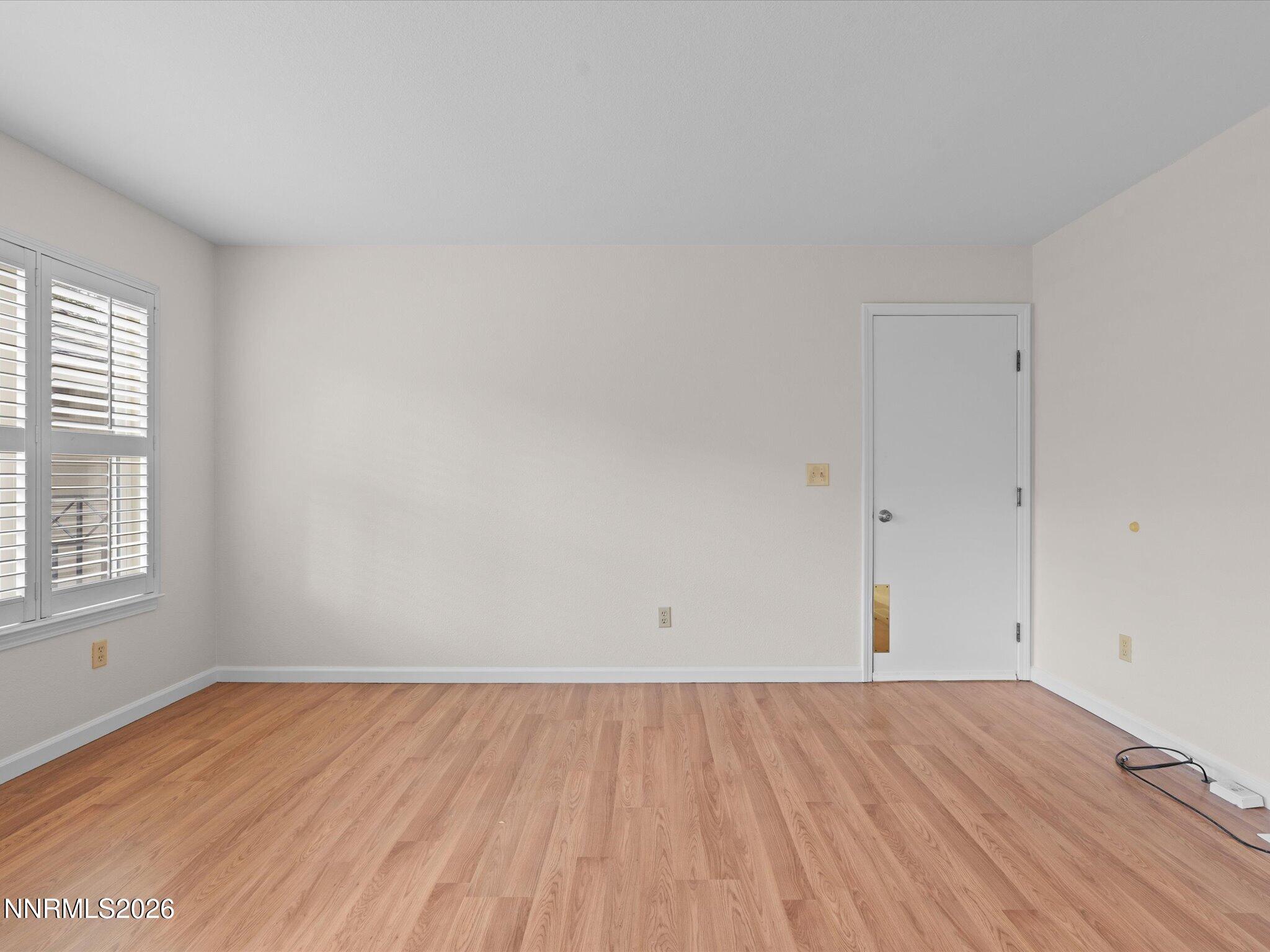 1280 Bridlewood Way Reno, NV 89509 - Photo 21 of 57 an empty room with a hardwood and windows