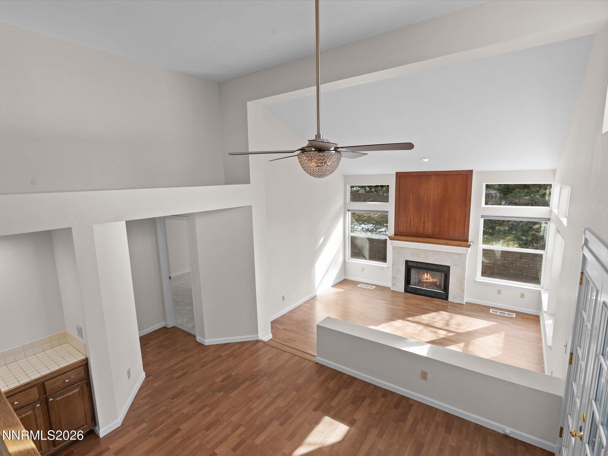 1280 Bridlewood Way Reno, NV 89509 - Photo 35 of 57 a living room with furniture a fireplace and a flat screen tv