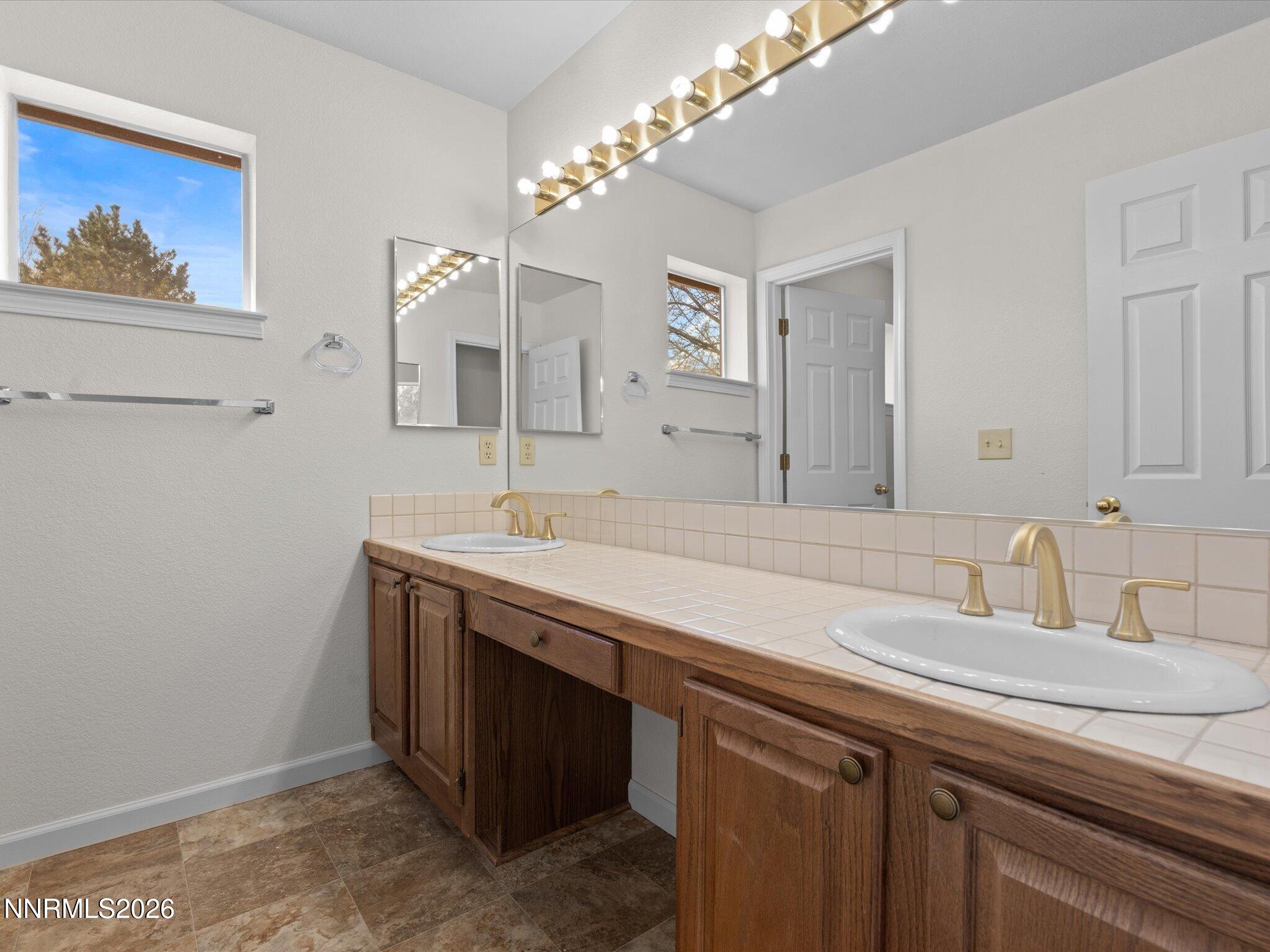 1280 Bridlewood Way Reno, NV 89509 - Photo 40 of 57 a bathroom with a sink and a mirror