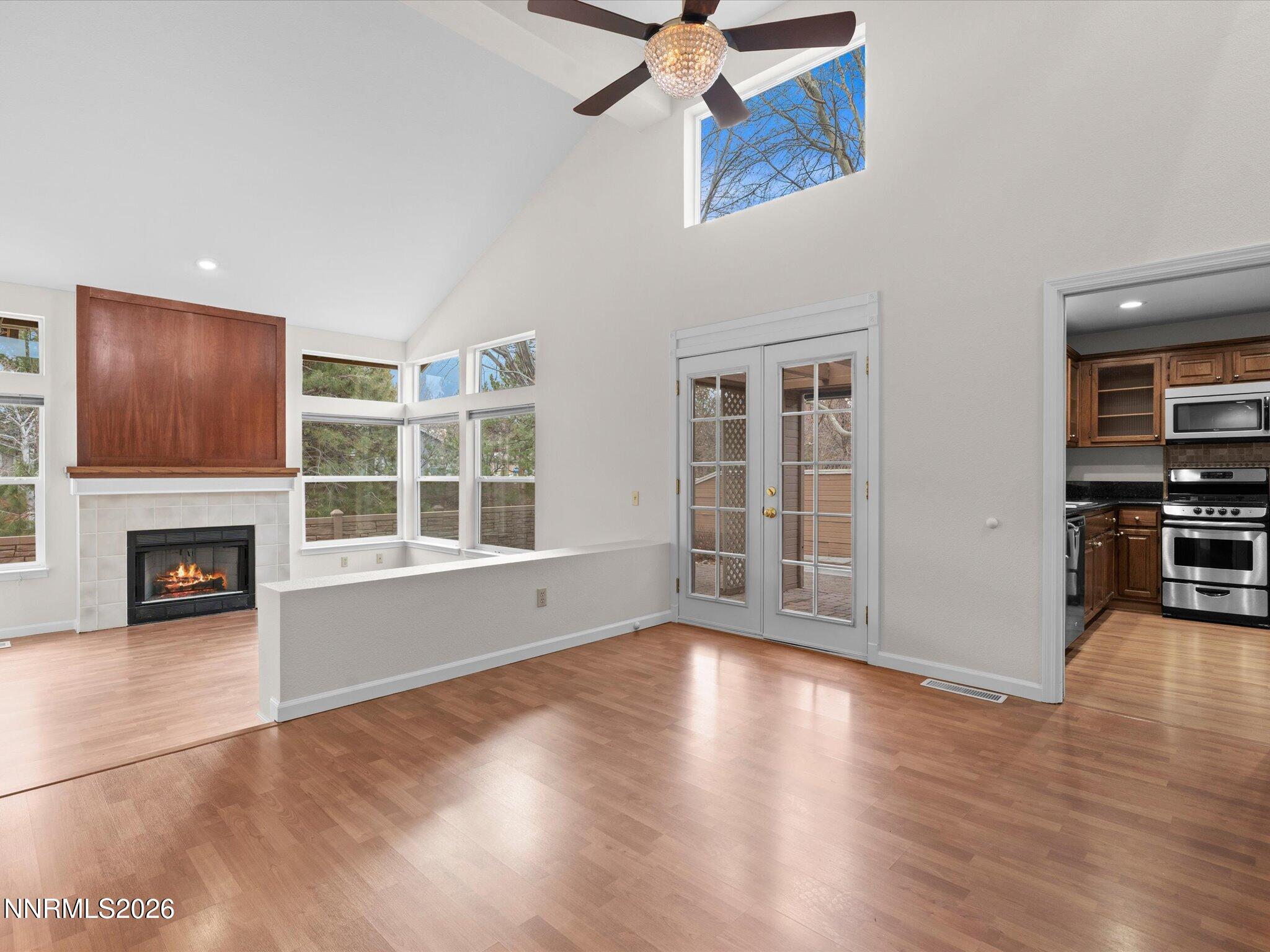 1280 Bridlewood Way Reno, NV 89509 - Photo 8 of 57 a view of an empty room with wooden floor fireplace and a window