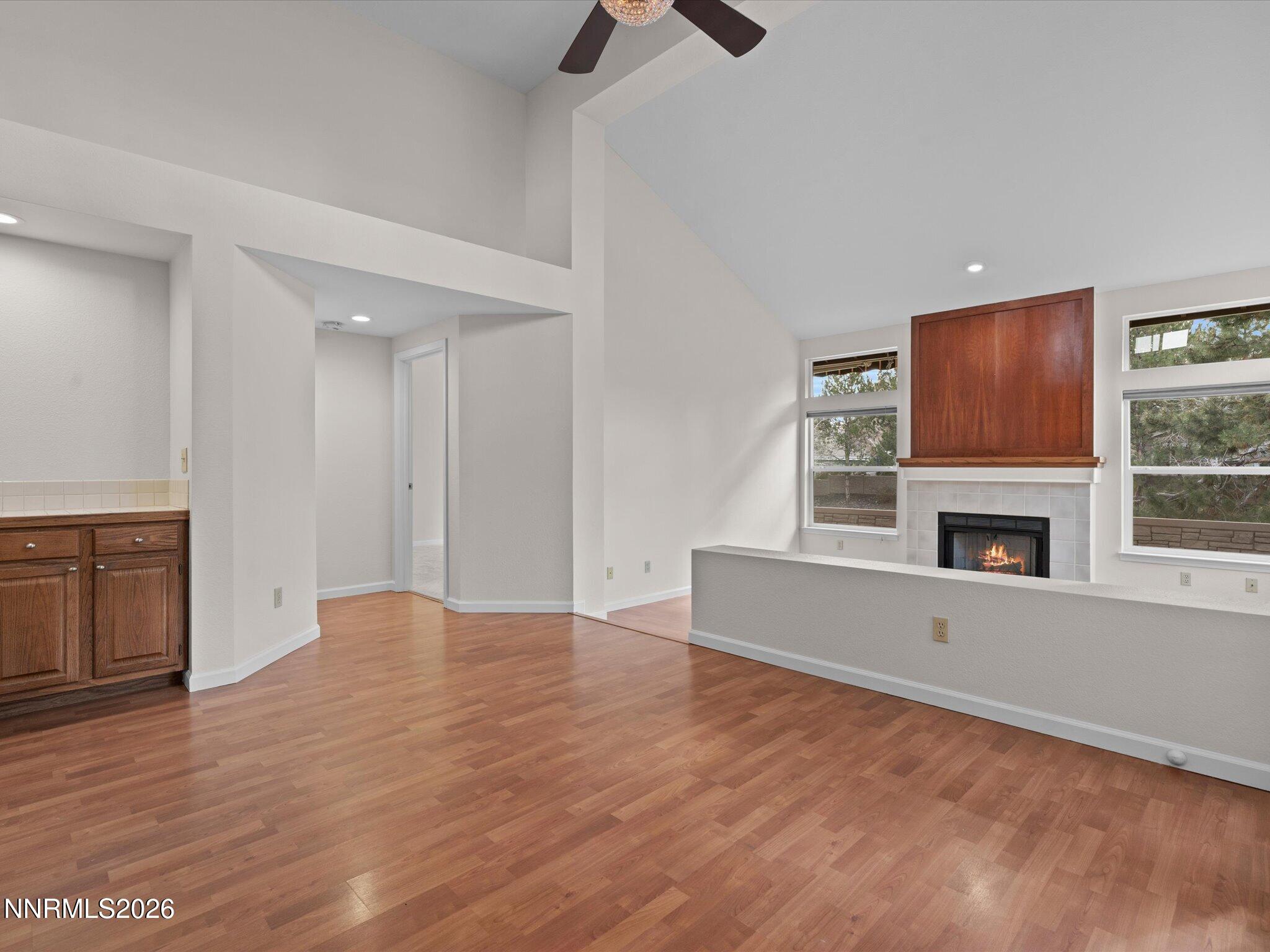 1280 Bridlewood Way Reno, NV 89509 - Photo 10 of 57 a view of an empty room with wooden floor and a fireplace