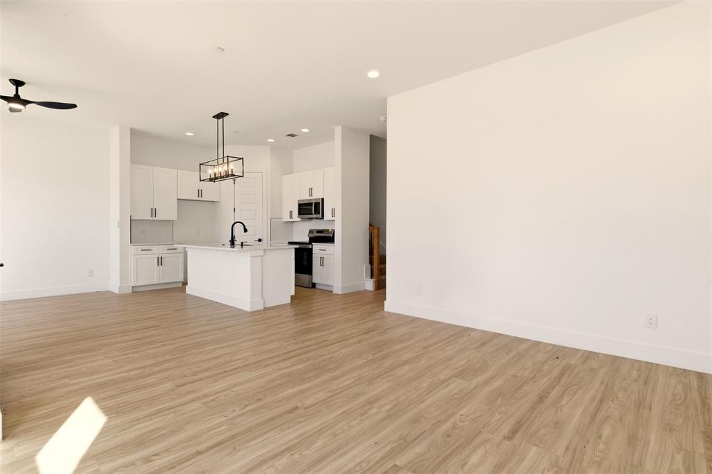8902 Lowell Street Rowlett, TX 75089 - Photo 7 of 32 Open concept living space featuring light-toned flooring, white walls, and recessed lighting