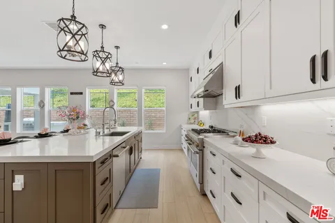a kitchen with a sink stove and cabinets